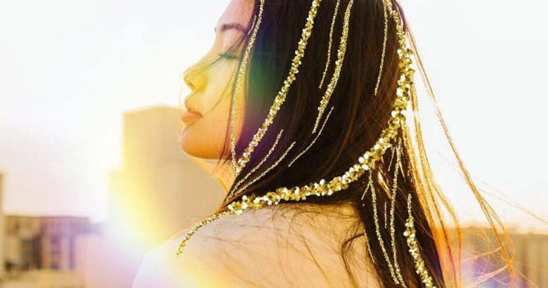 Photo of a girl with gold glitter brush