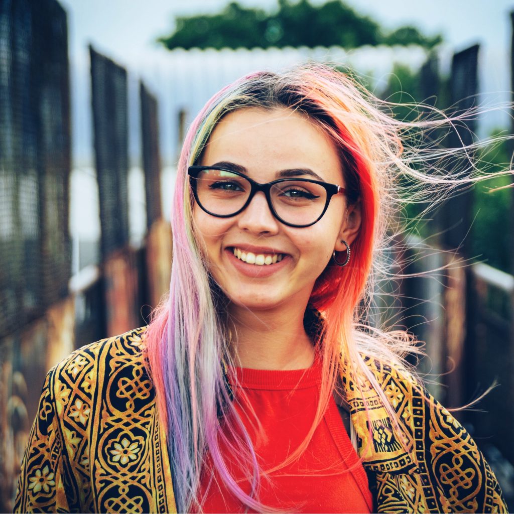 Young trendy girl with colorful hair taking a selfie