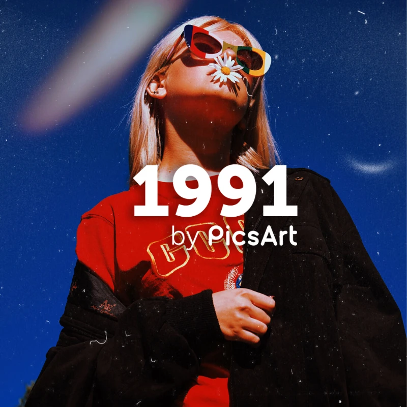 girl with sunglasses holding chamomile in her mouth