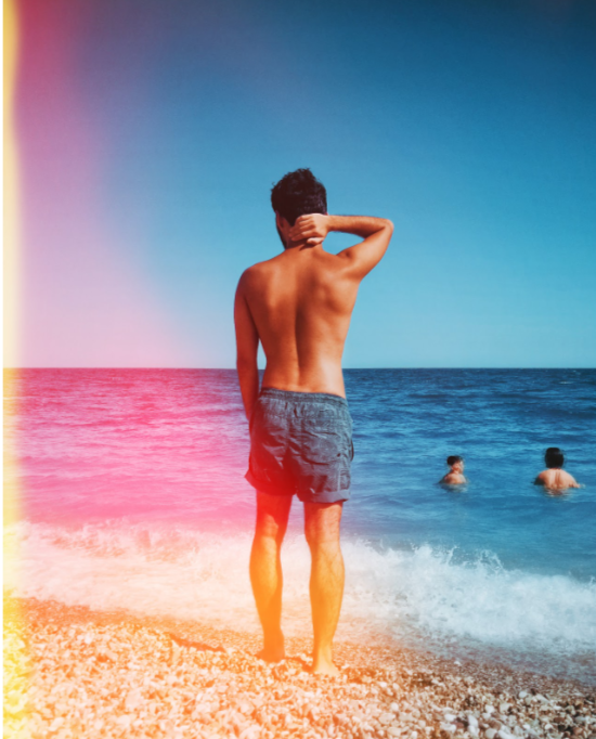 boy standing on the beach with color filter