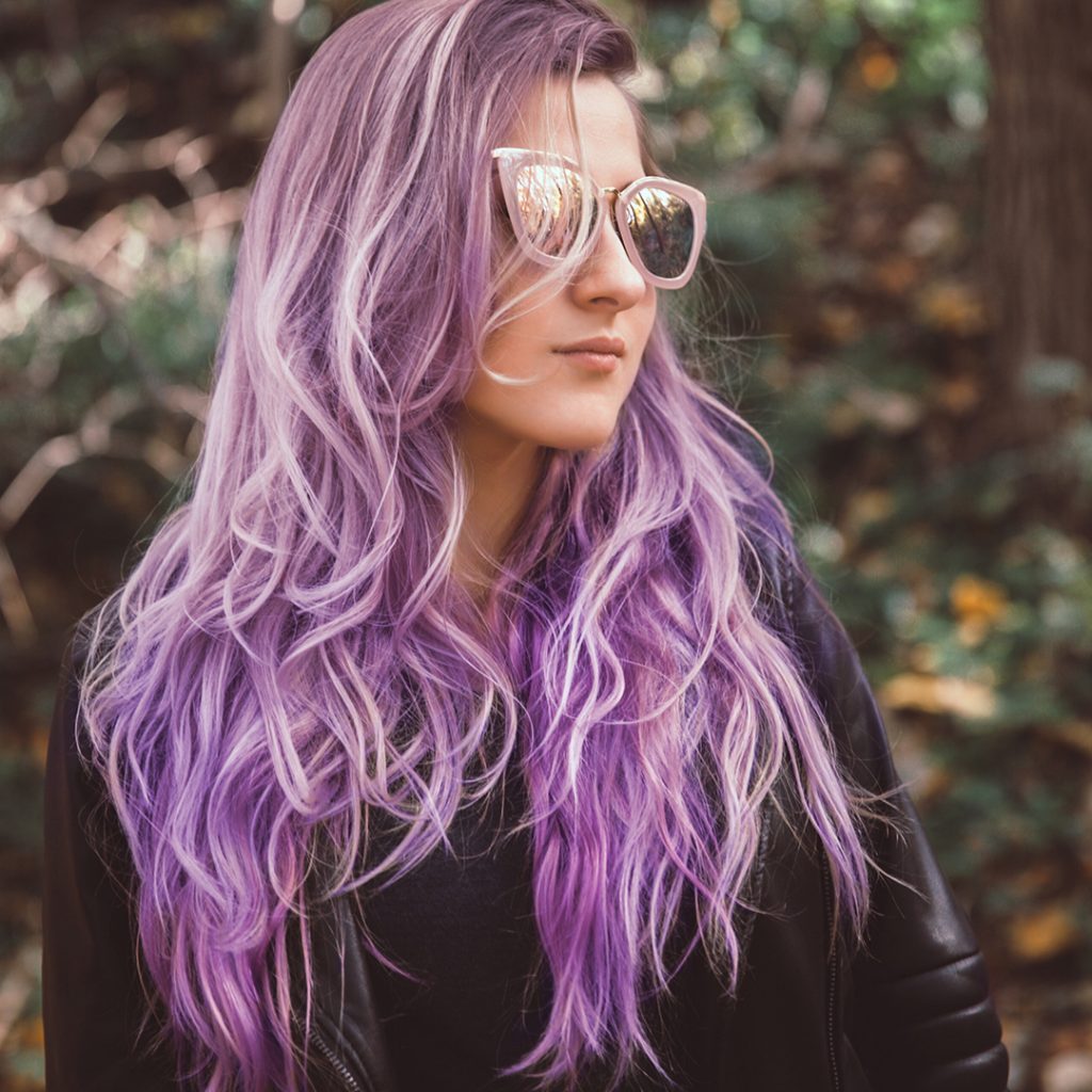 girl with purple hair wearing sunglasses