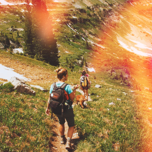 girls hiking through green mountains with light masks filter