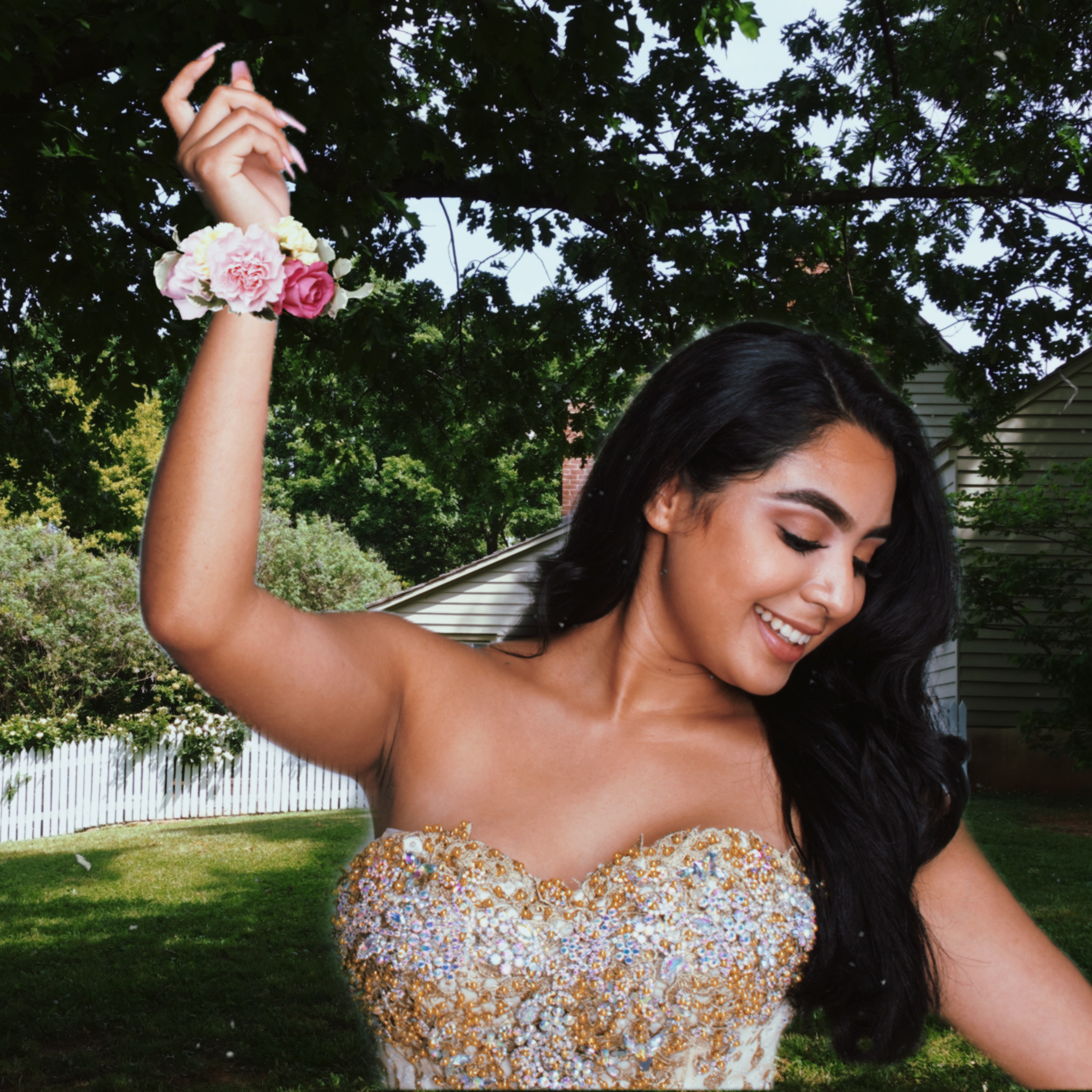 smiling brunette girl in prom party dress with a nice corsage around her wrist