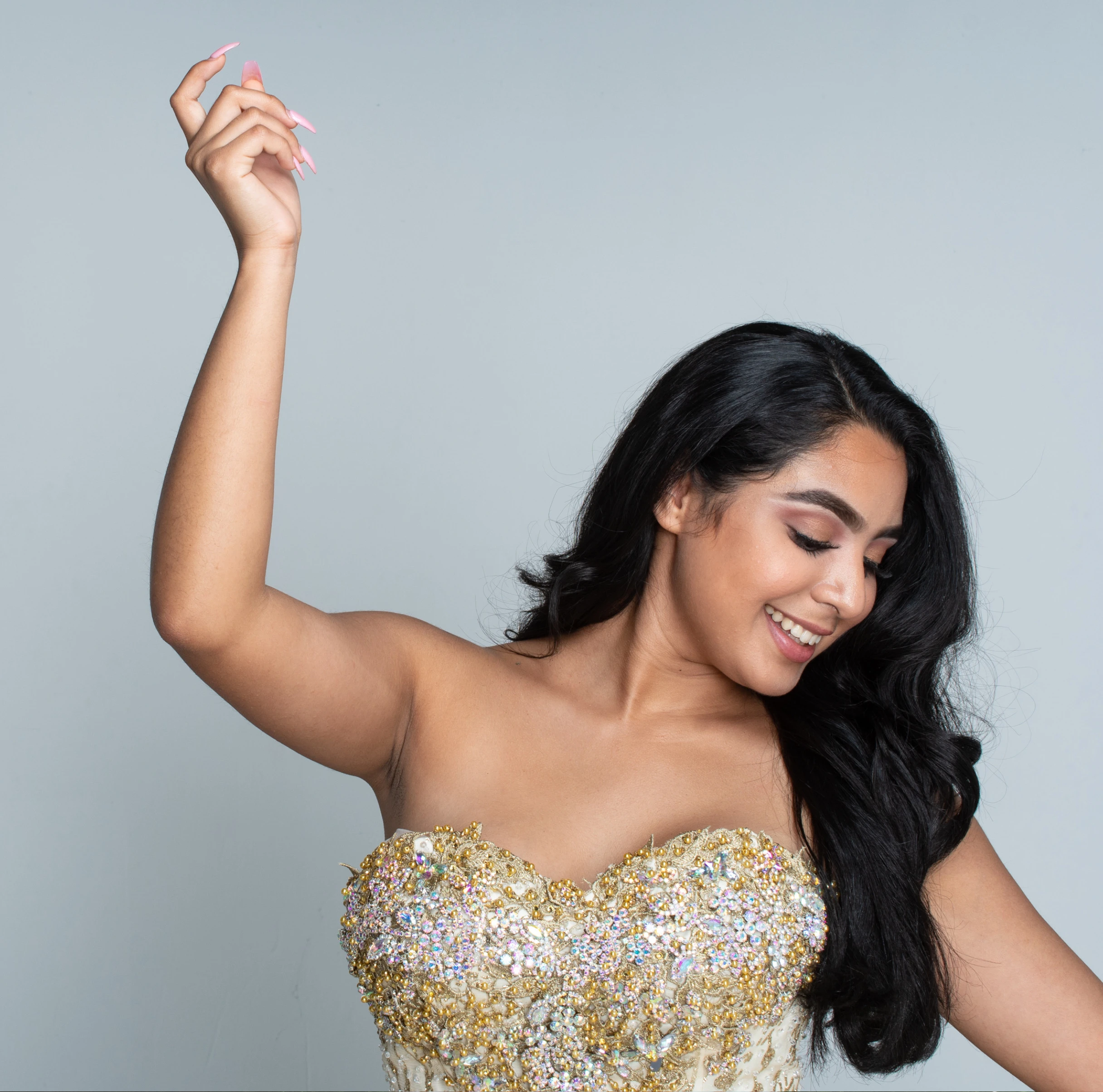 smiling brunette girl in prom party dress in gentle hand up standing