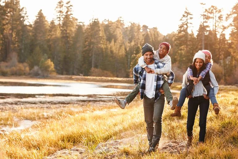 Fall family photo with lake and leaves