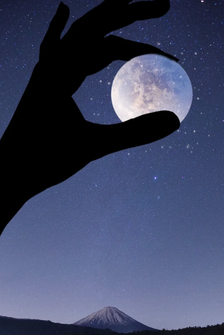 Hand holding the moon