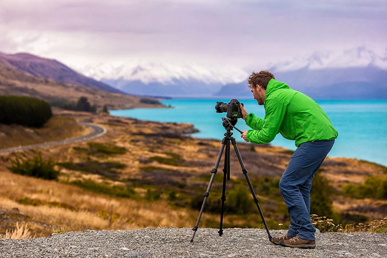 documentary photographer capturing a mountain lake setting