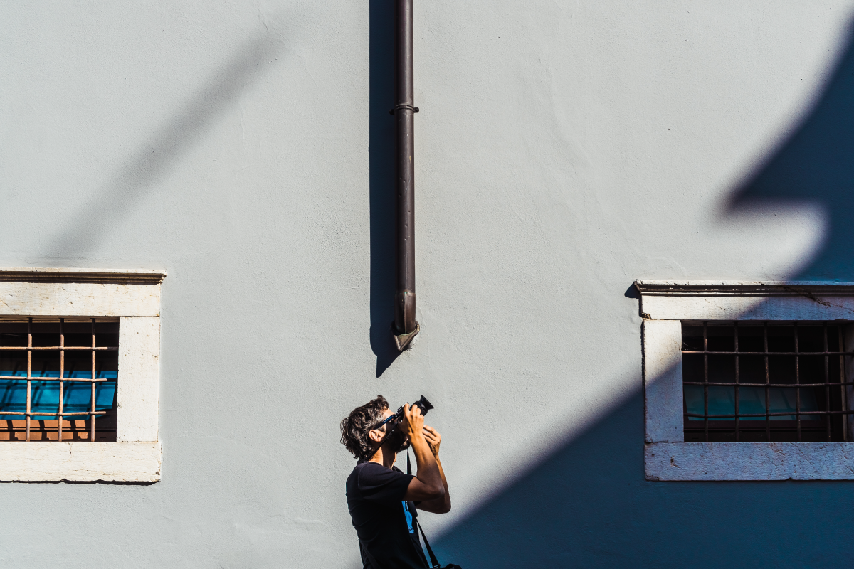 photographer capturing a photo of a building