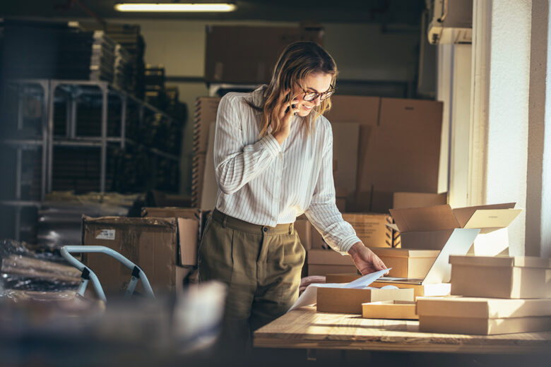 business owner looking at products in boxes