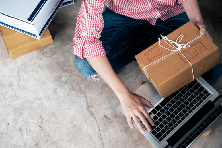 business owner setting up product box to mail