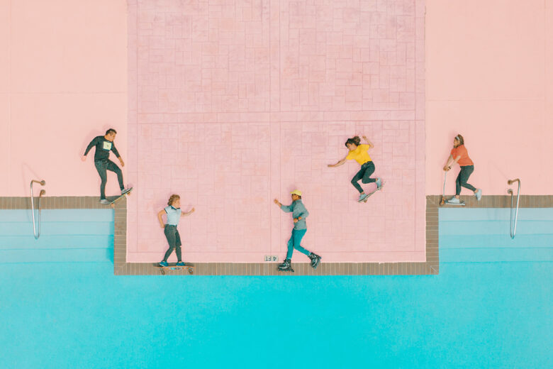 people skateboarding by a pool with pastel pink ground