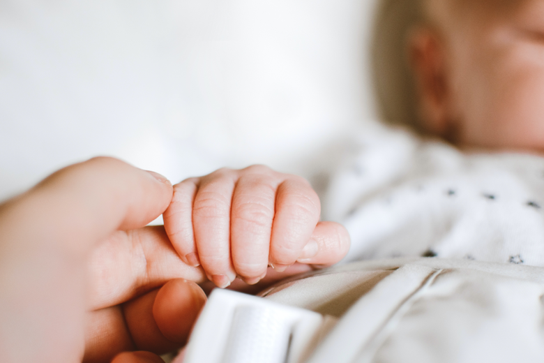 baby hand wrapped around parent's finger photo idea for newborn