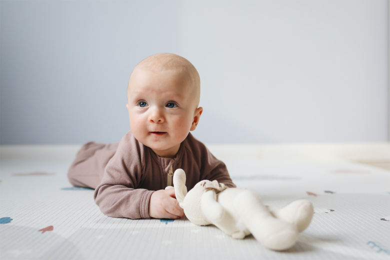 baby holding bunny toy