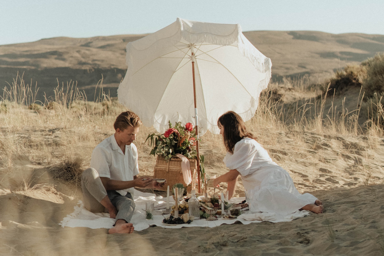 romantic summer photoshoot idea of a beach picnic