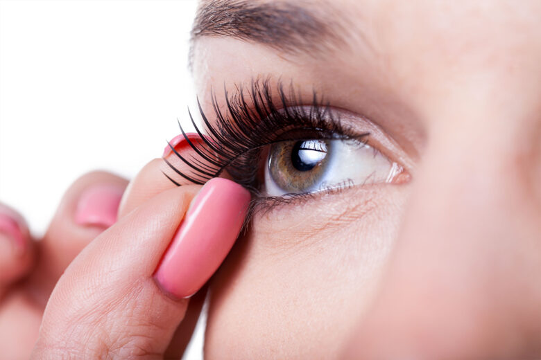 applying false eyelashes