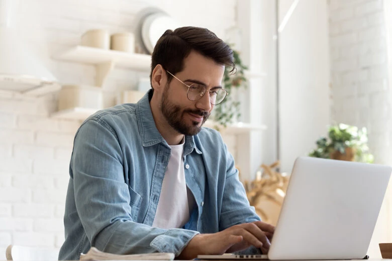 man sitting at laptop screen to create pdf file