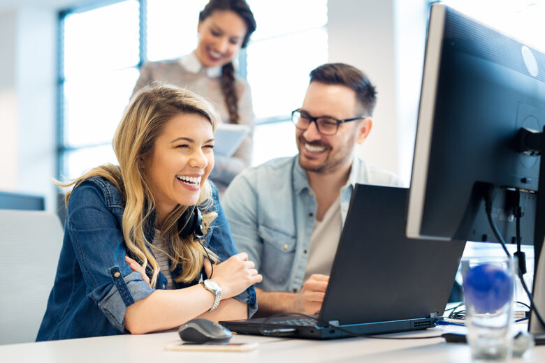 coworkers looking at computer together